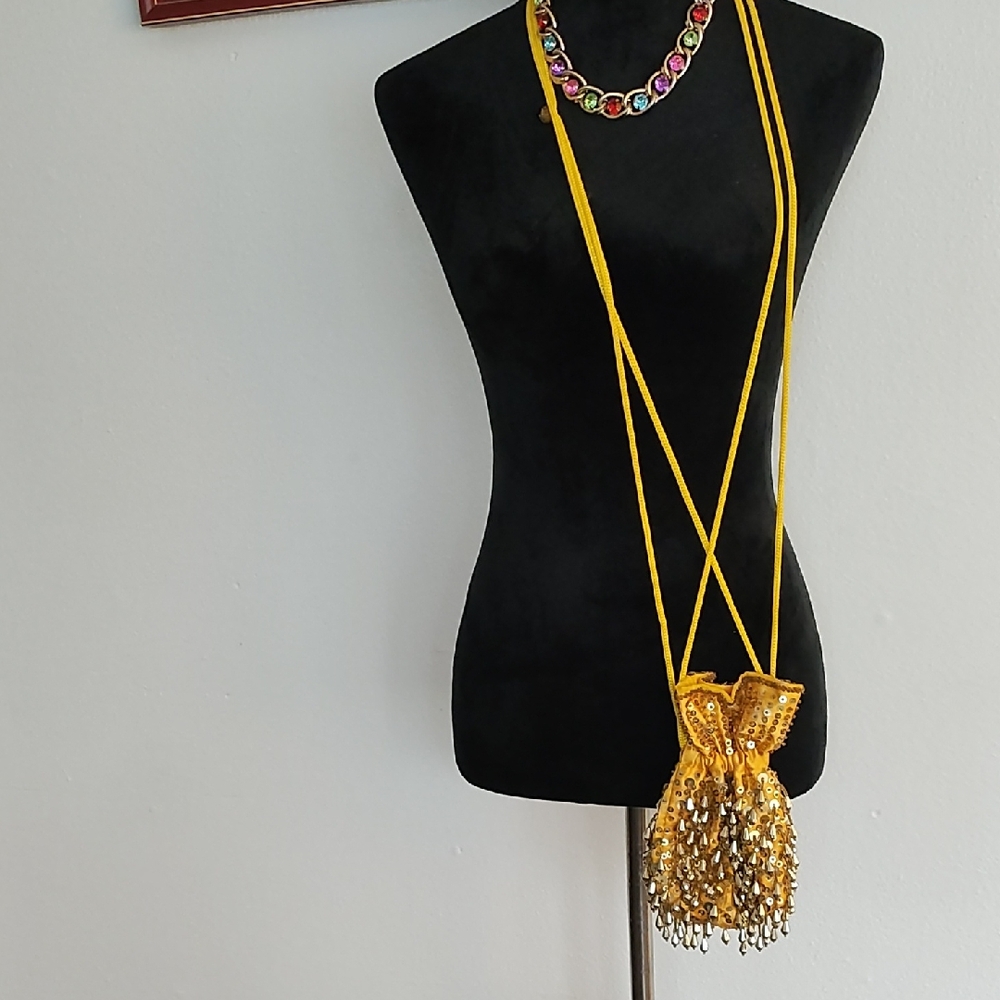Unknown satin pouch with gold detailing thru-out the pouch